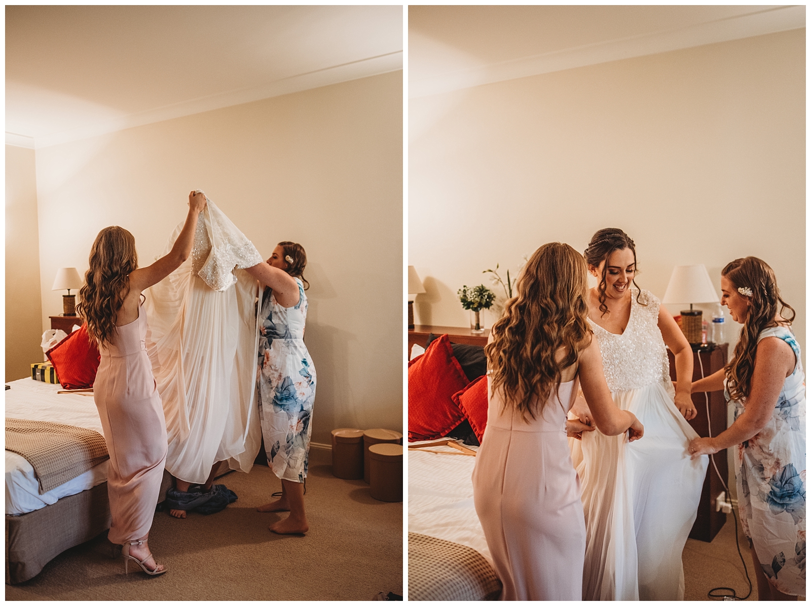 Two women help slide wedding dress over brides head. Bride with dress on smiling.